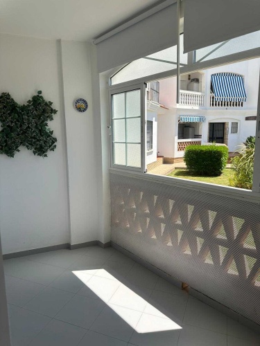 Apartamento Laguna de El Portil, alquiler temporada, piscina, pista de pádel, terraza acristalada, plaza de garaje

